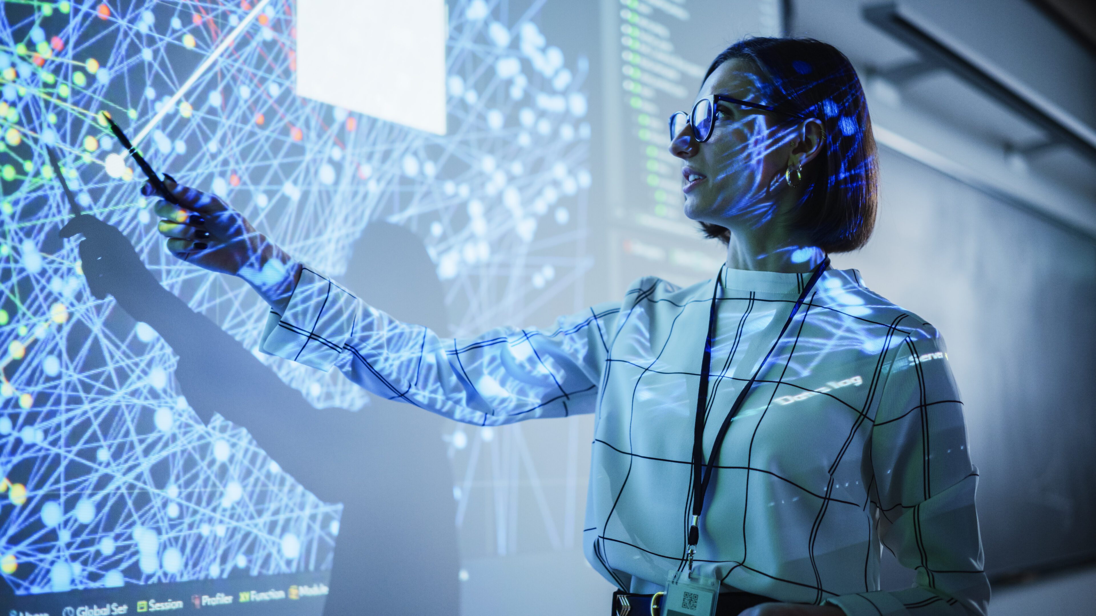 Woman presenting data on interactive screen.