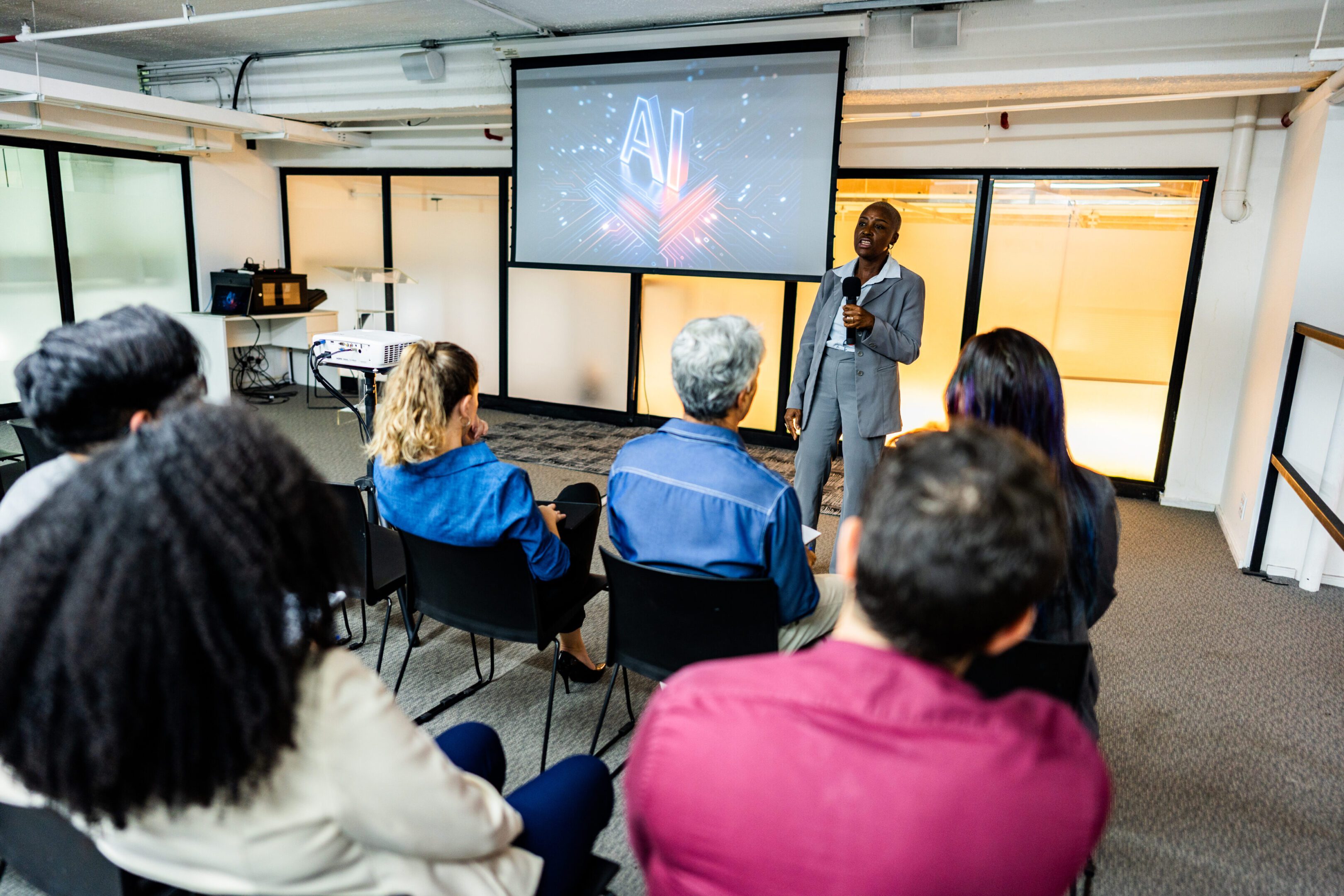 Man presenting AI lecture to seated audience.